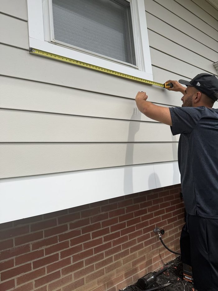 Becker Alrub measuring for a siding installation